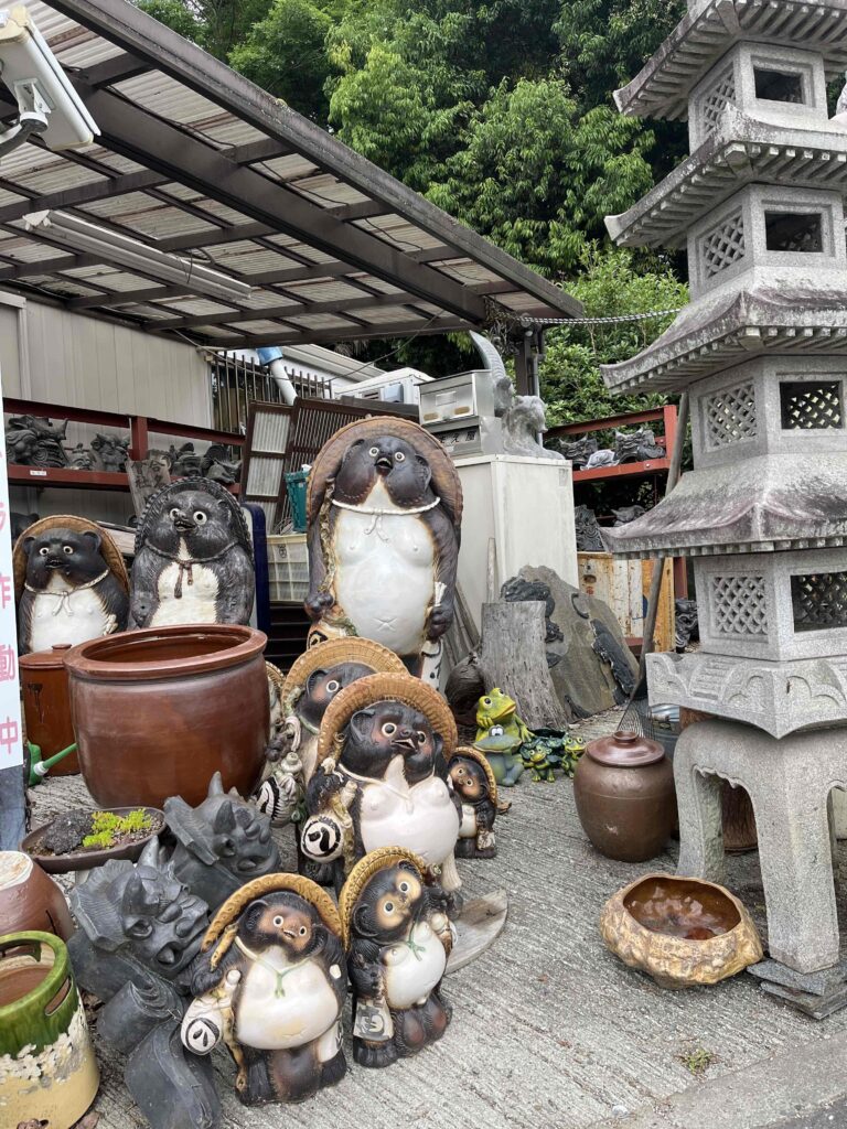 Garden and yard statues of tanuki, Japanese racoons, at a outdoor shop in rural Japan.