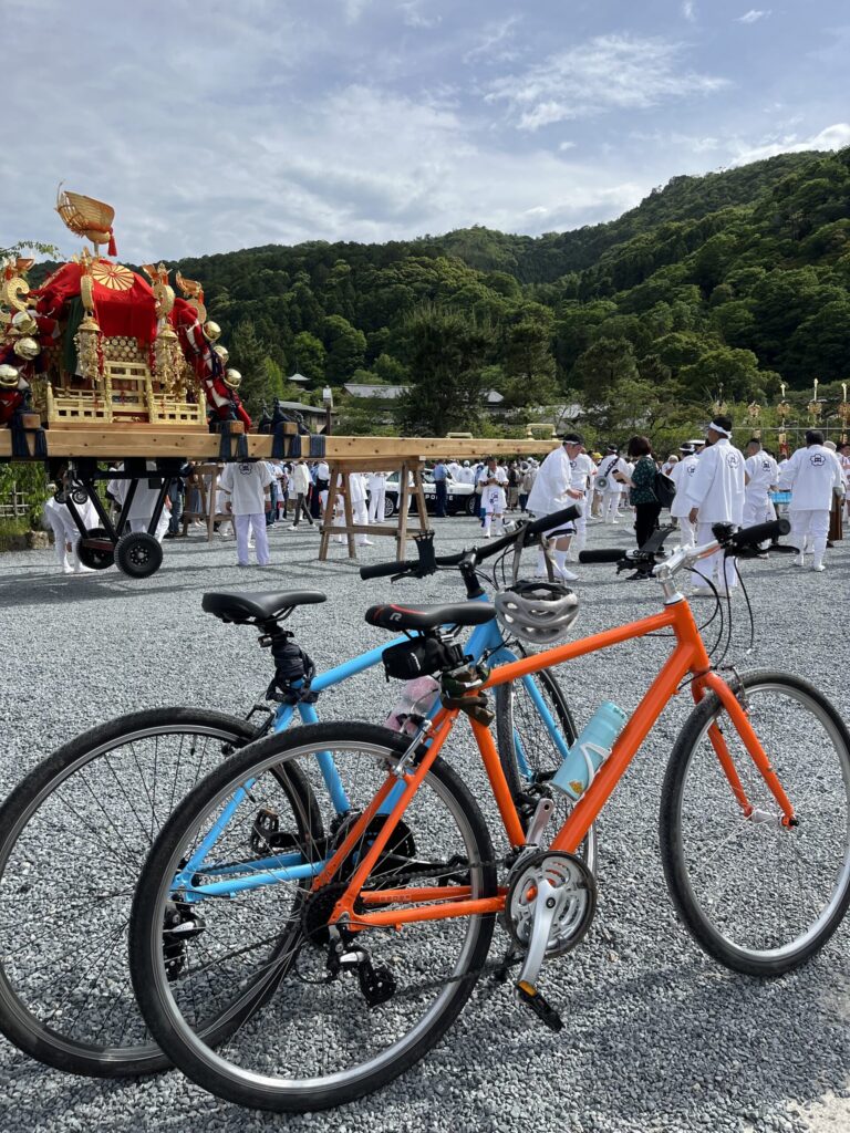Two bicycles rest next to the preparations for a Japanese spring festival called a Matsuri.