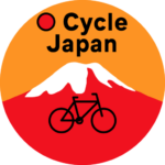 cropped-Logo-No-Website.png O Cycle Japan logo with orange background, red mountain with white cap and outline of a bicycle in the front with the name.