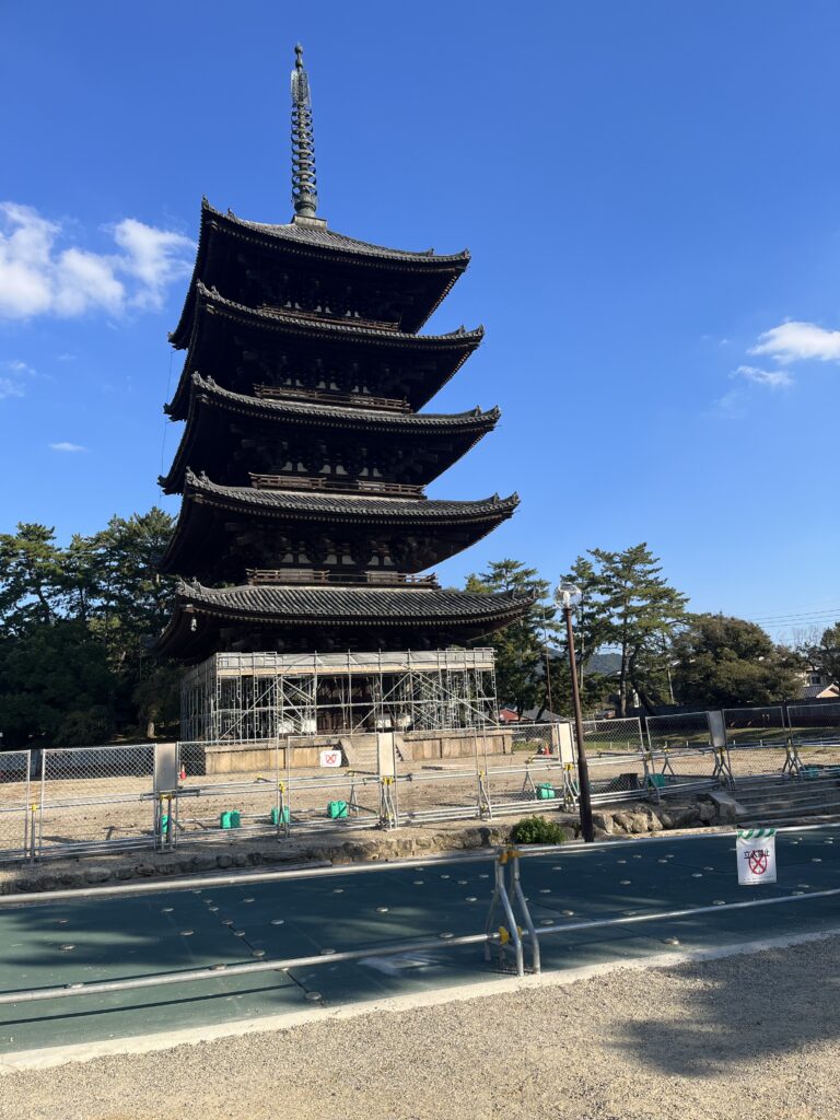 Five story pagoda, Kohfukuji temple in Nara with metal fencing around it as maintenance work takes place on the first level.