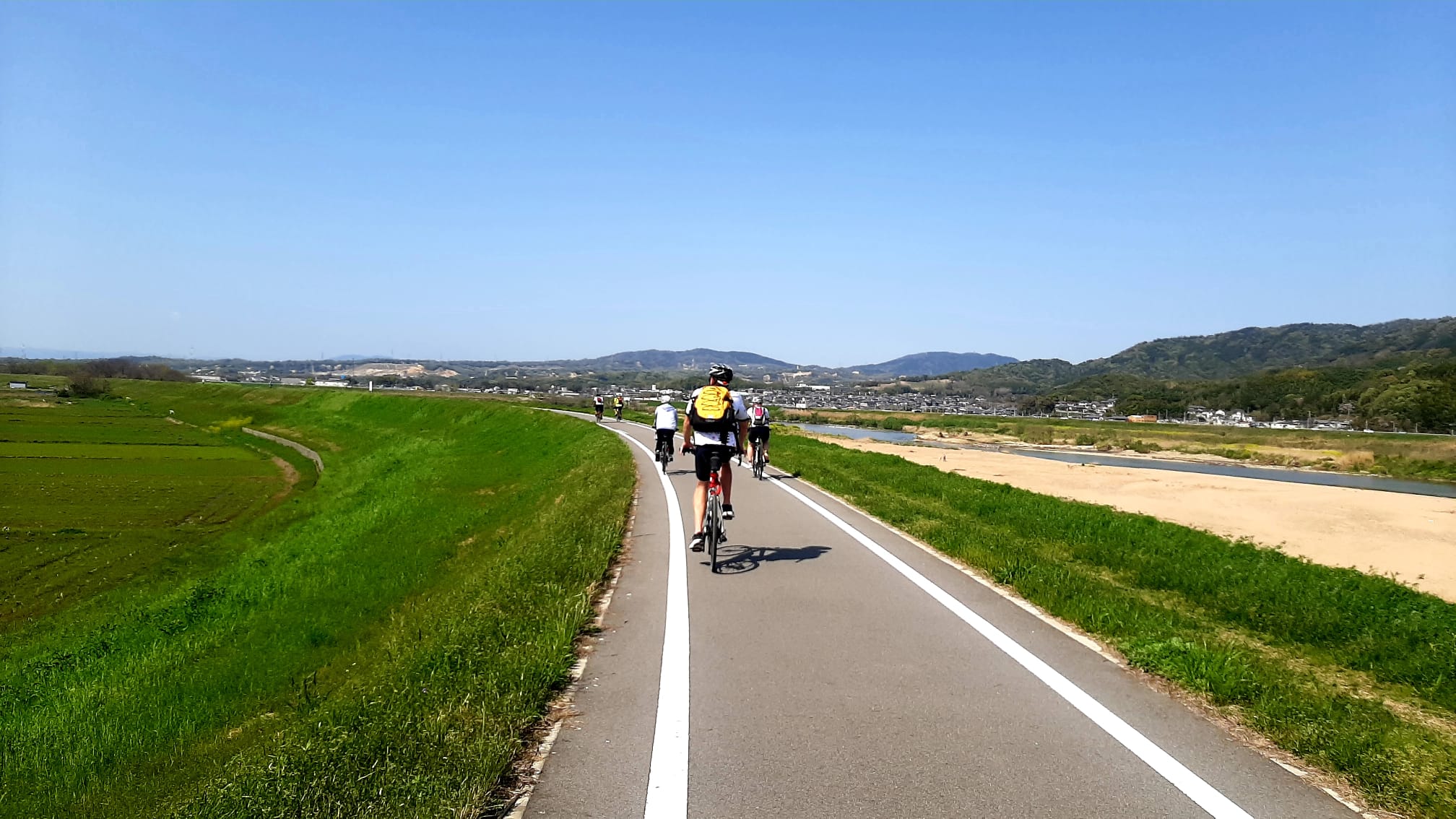 Rice fields and the river surround this beautiful cycle path in Japan.