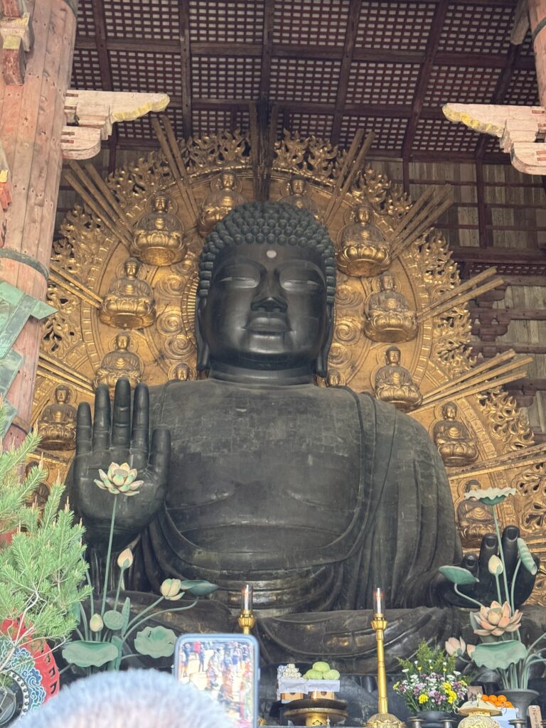 Large city Buddha statue with gold designed background. 