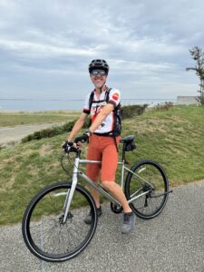 Smiling cyclists poses while taking a break from cycling.