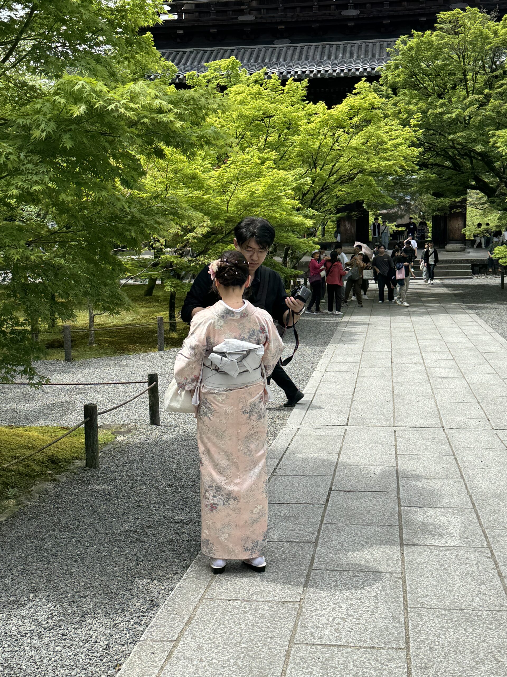 Woman in Kimono at Japanese temple garden.