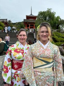 Two woman pose in beautiful colorful flower Kimonos at Kyomizu-dera in Kyoto.