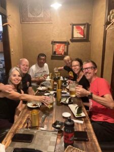 Group raises their beers at an Izakaya dinner in Japan.