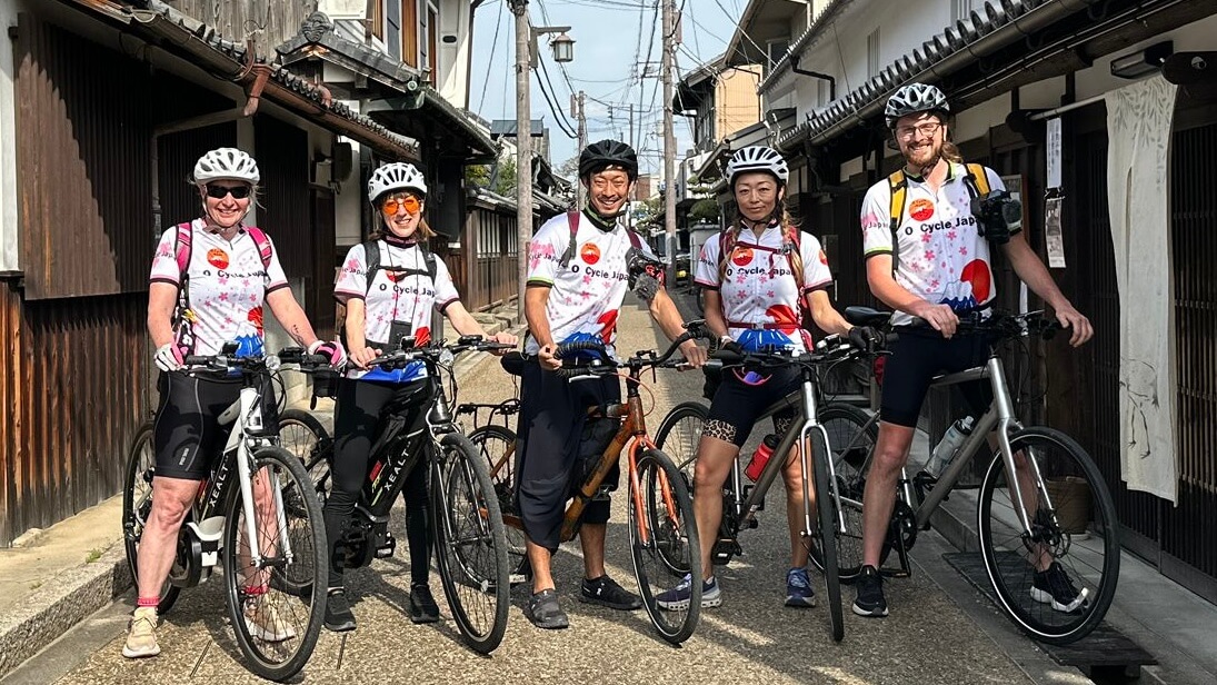 Group of O Cycle Japan cyclists pose for a photo in the old traditional town of Imaicho.