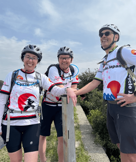 Cyclists stop to enjoy the view of the Japanese oceanside.