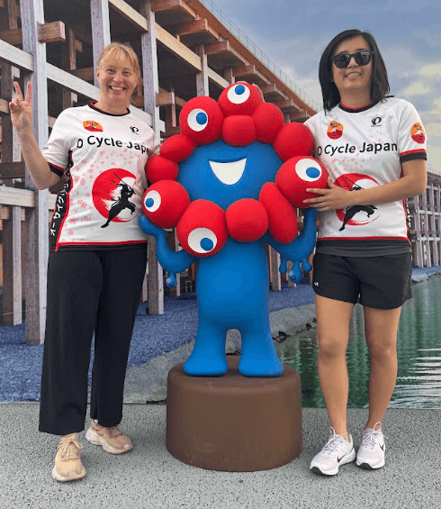 Osaka Expo 2025. O Cycle Japan guests pose with mascot Myaku-Myaku.